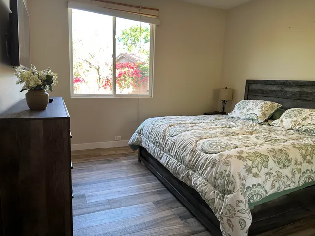 a bed sitting in a bedroom next to a window