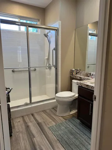 a bathroom with a toilet and a shower