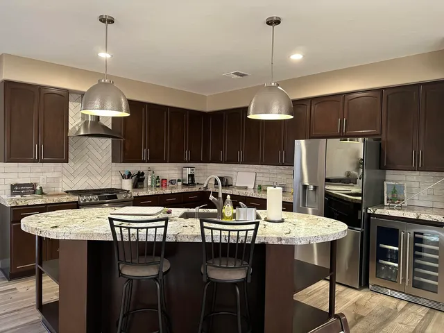 a kitchen with a dining table chairs sink and microwave
