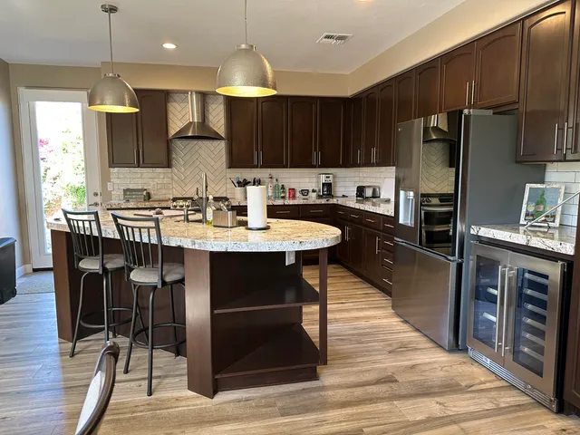 a kitchen with granite countertop a sink appliances cabinets and counter space
