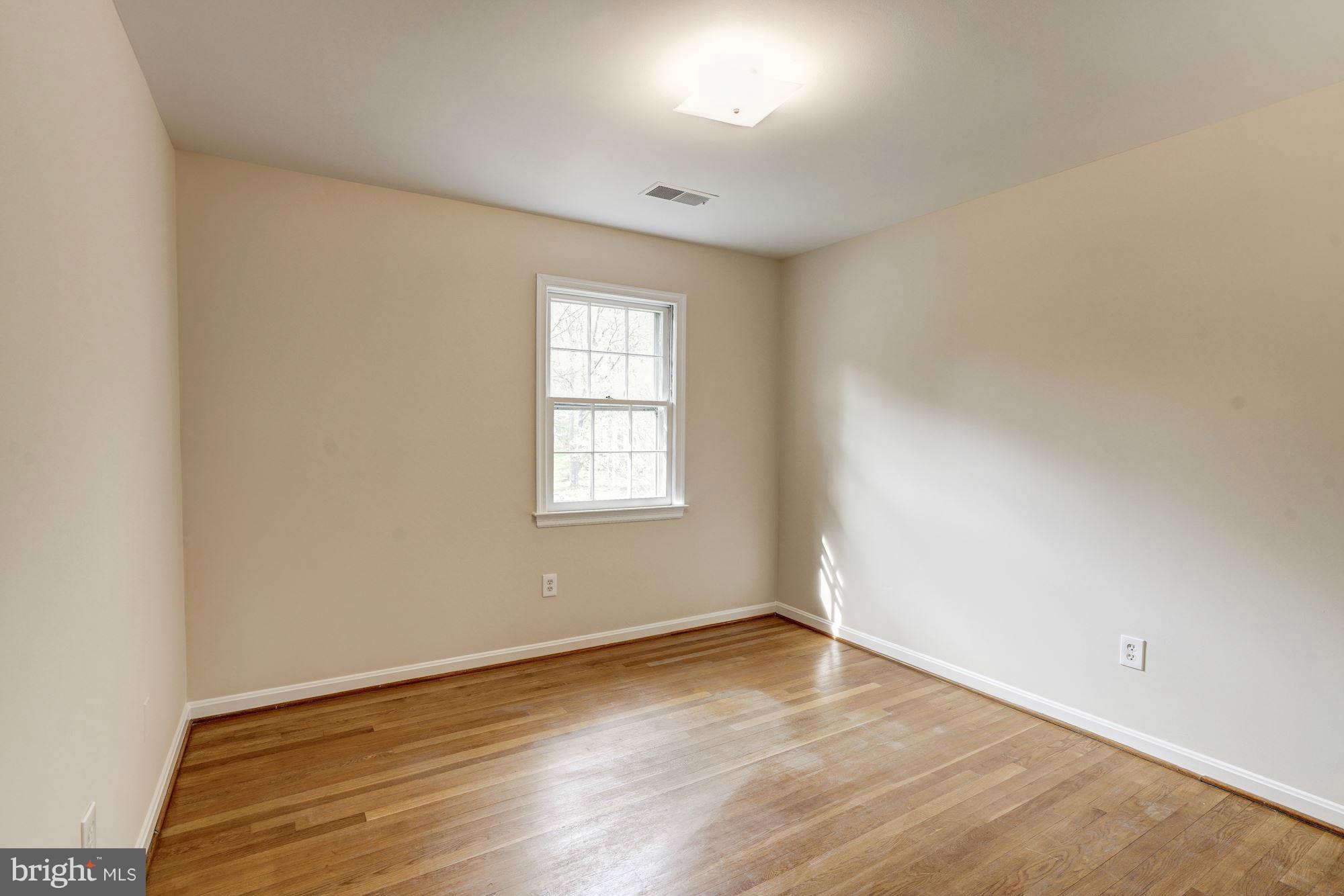 11037 Ring Road Reston, VA 20190 - Photo 19 of 30 an empty room with wooden floor and windows