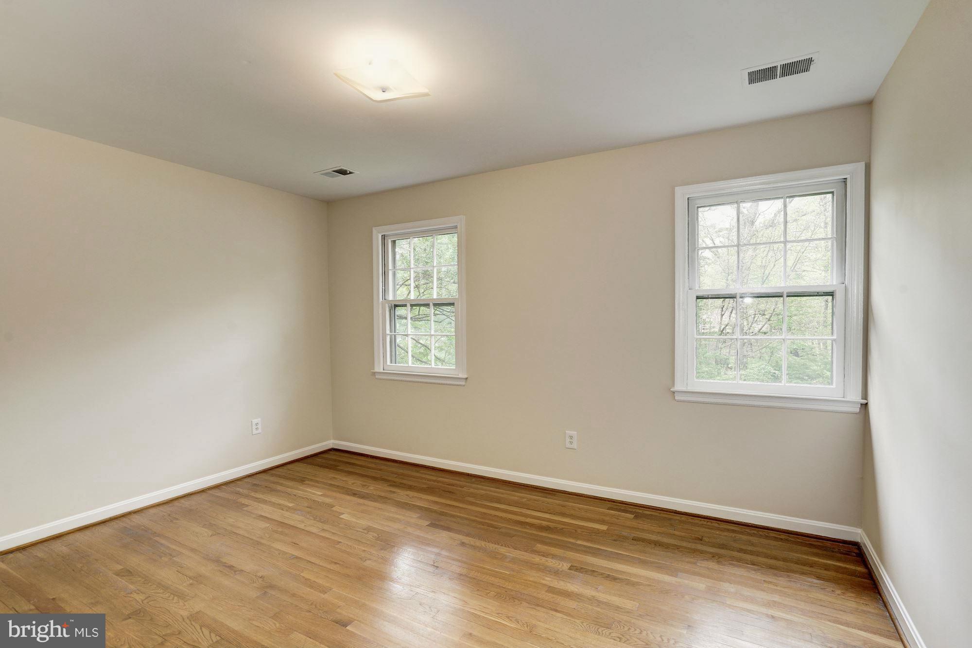 11037 Ring Road Reston, VA 20190 - Photo 20 of 30 an empty room with wooden floor and windows
