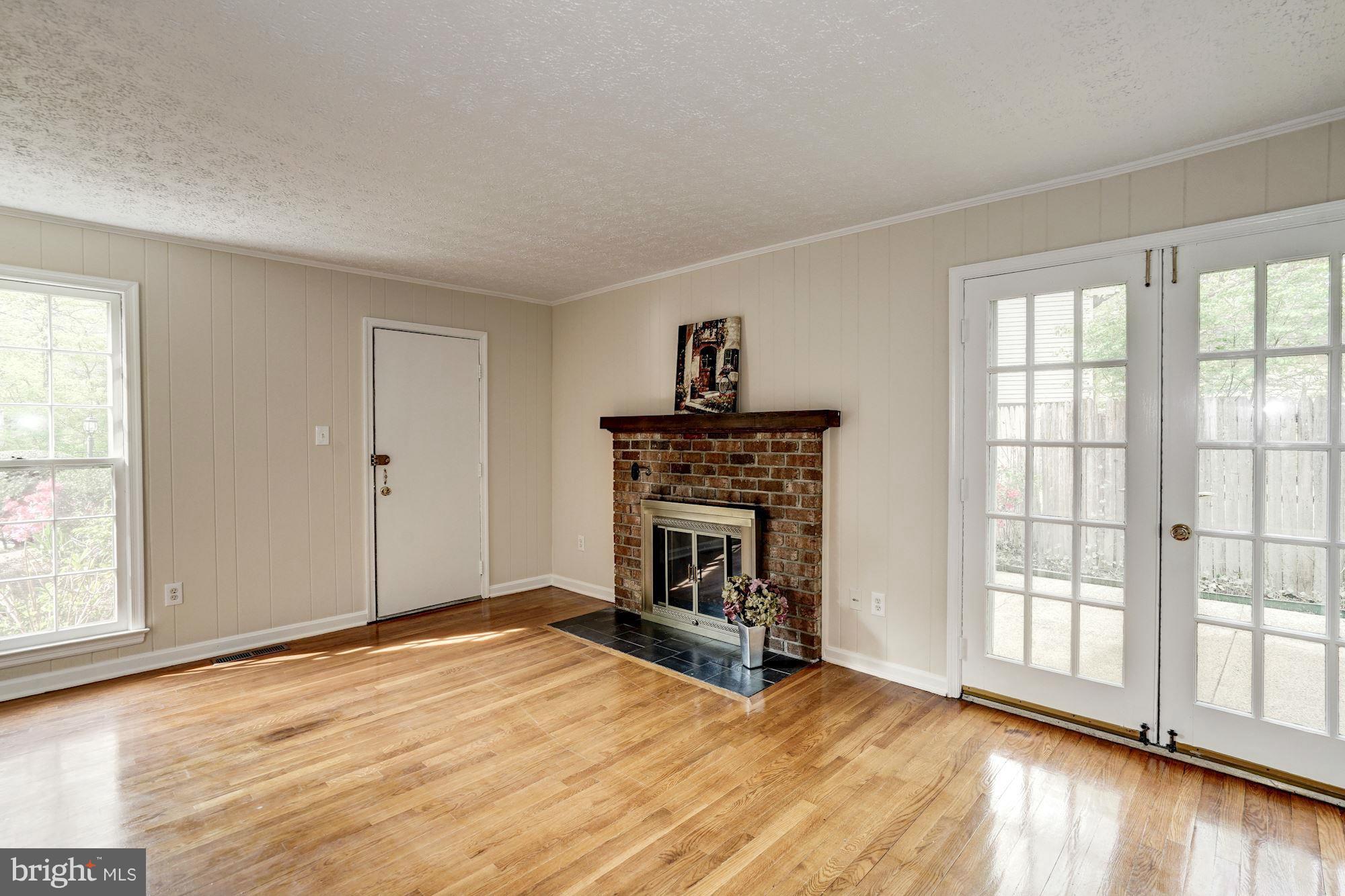 11037 Ring Road Reston, VA 20190 - Photo 3 of 30 a view of empty room with wooden floor and fireplace