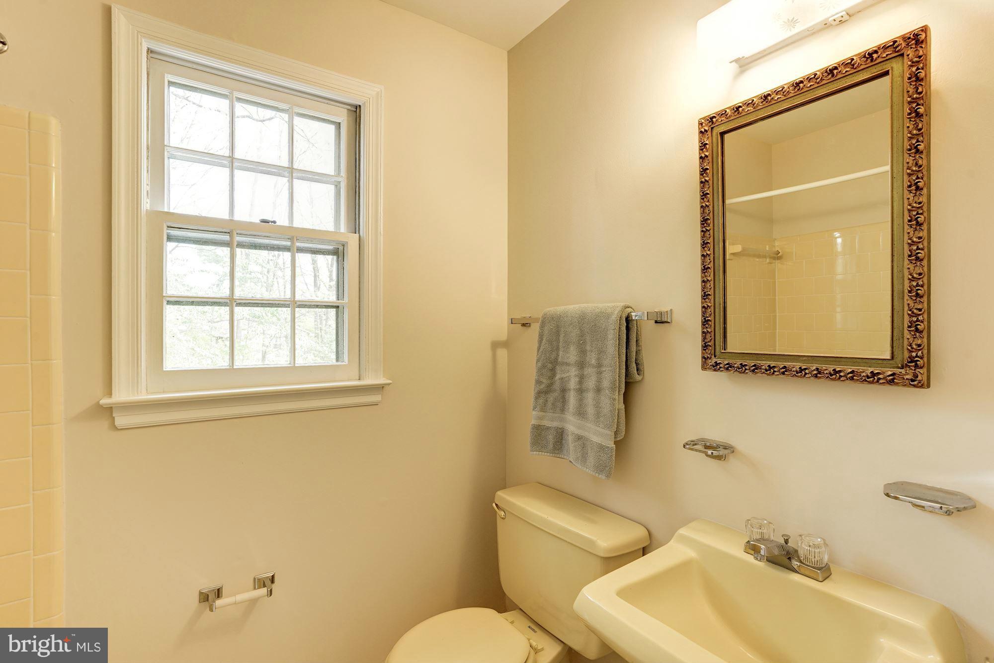 11037 Ring Road Reston, VA 20190 - Photo 21 of 30 a bathroom with a toilet sink vanity and mirror