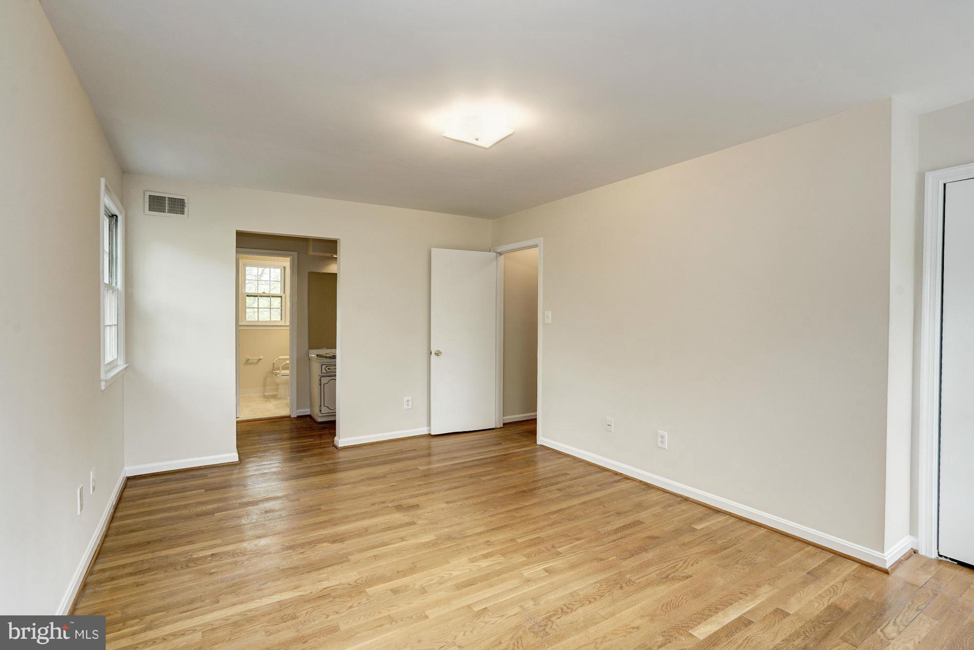 11037 Ring Road Reston, VA 20190 - Photo 4 of 30 a view of an empty room with wooden floor and closet