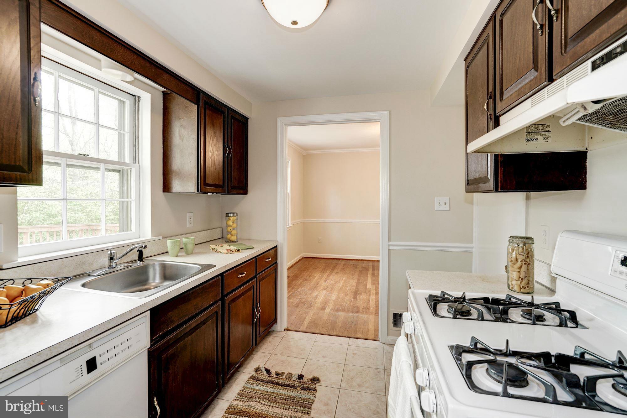11037 Ring Road Reston, VA 20190 - Photo 6 of 30 a kitchen with a stove and a sink