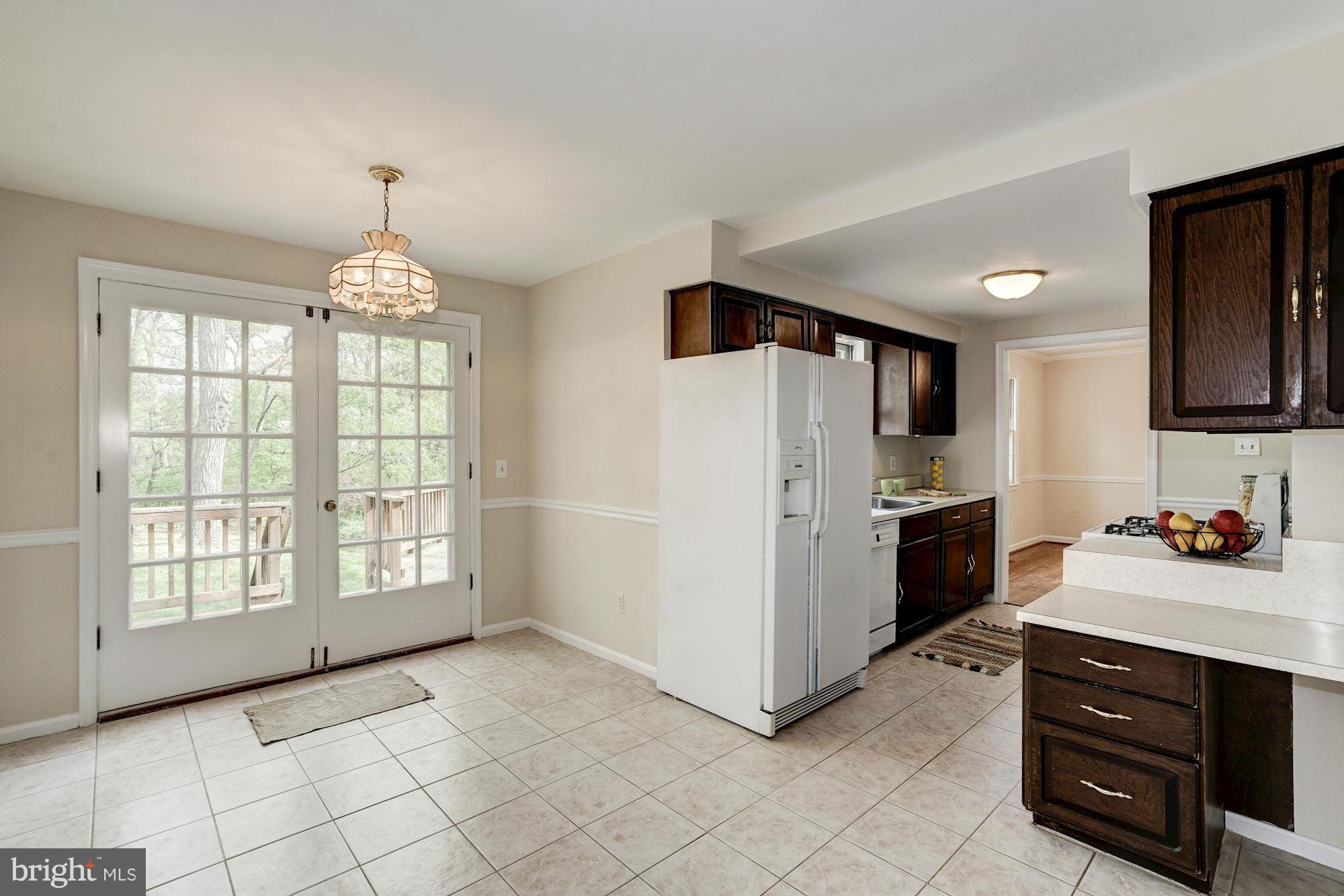 11037 Ring Road Reston, VA 20190 - Photo 9 of 30 a kitchen with stainless steel appliances a refrigerator sink and cabinets
