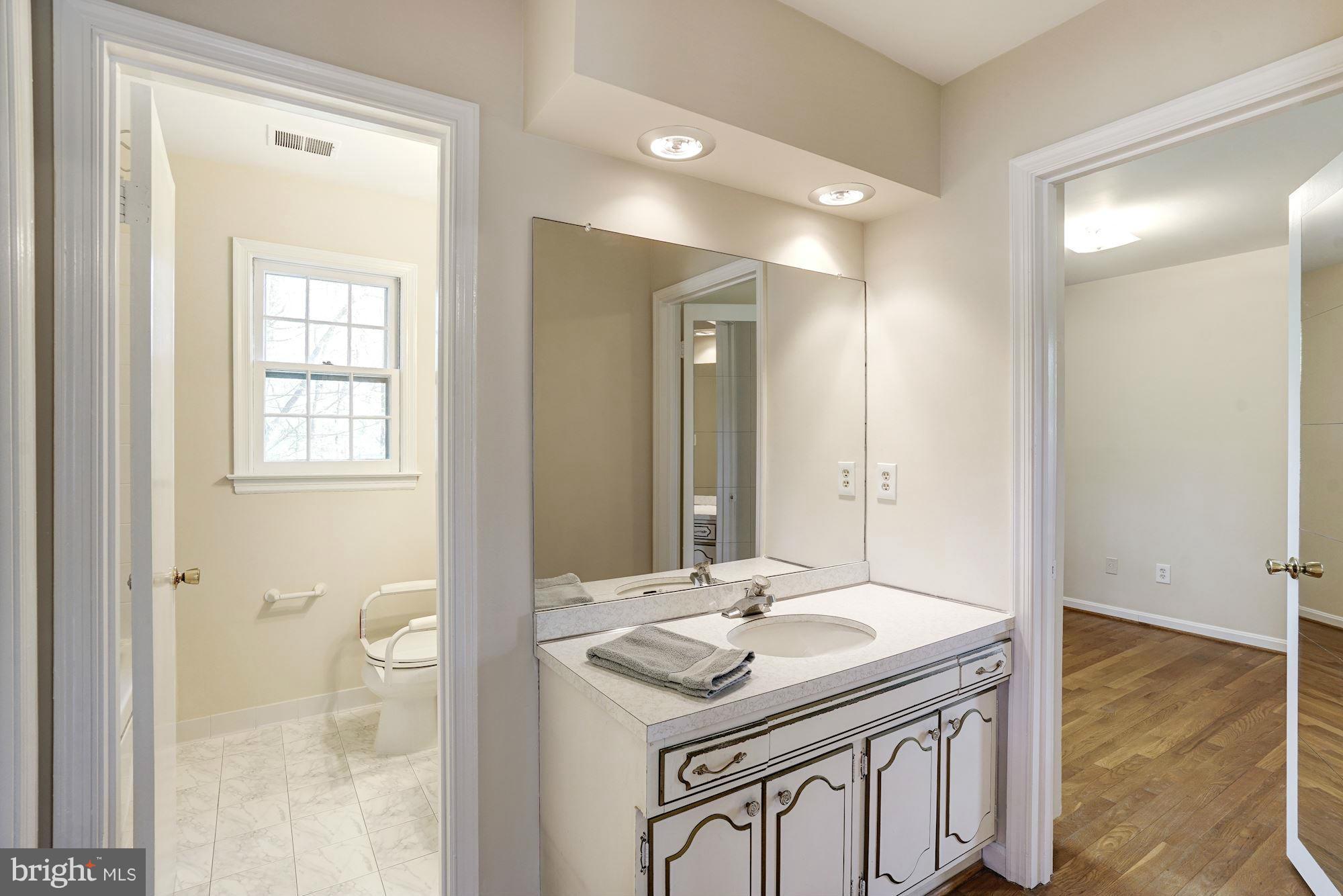 11037 Ring Road Reston, VA 20190 - Photo 10 of 30 a bathroom with a sink a toilet and a mirror