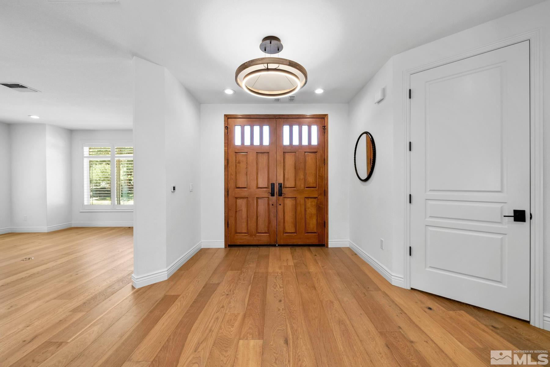 13000 Silver Wolf Road Reno, NV 89511 - Photo 12 of 43 a view of empty room with window and wooden floor