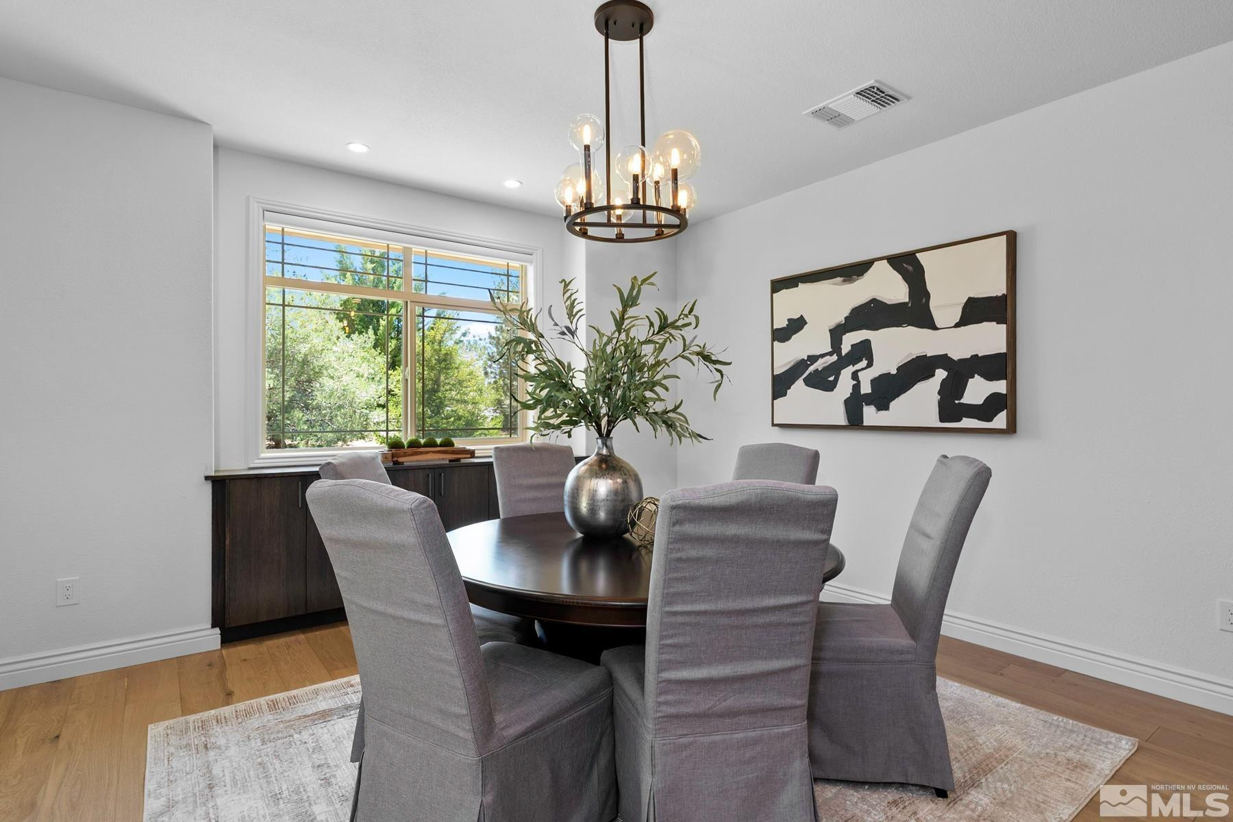 13000 Silver Wolf Road Reno, NV 89511 - Photo 5 of 43 a dining room with furniture potted plants and wooden floor