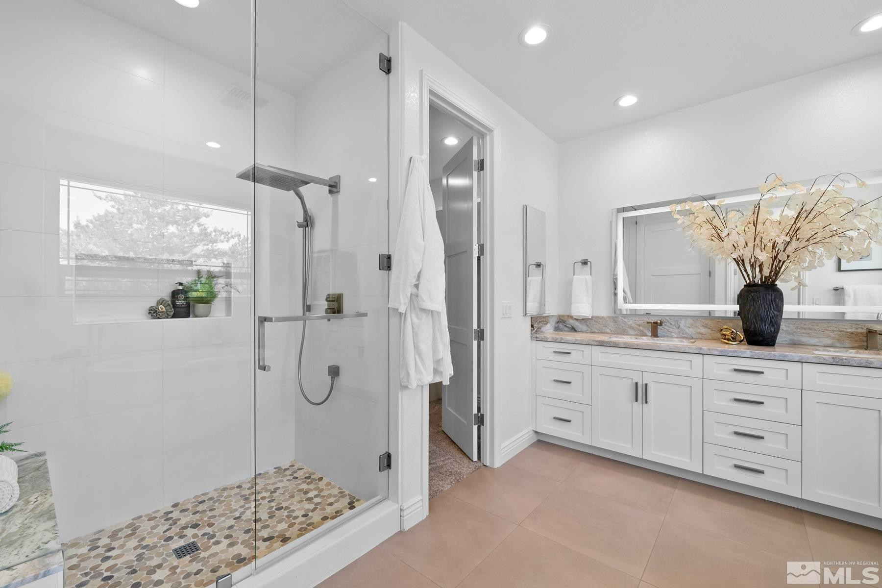 13000 Silver Wolf Road Reno, NV 89511 - Photo 7 of 43 a bathroom with a granite countertop sink a mirror a glass door a shower and a bathtub