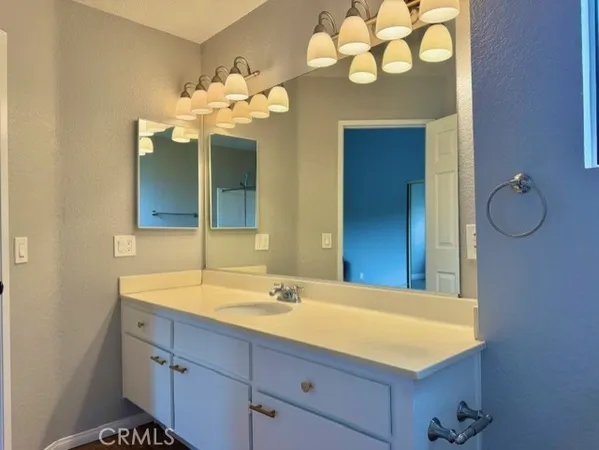 a bathroom with a sink vanity and a mirror