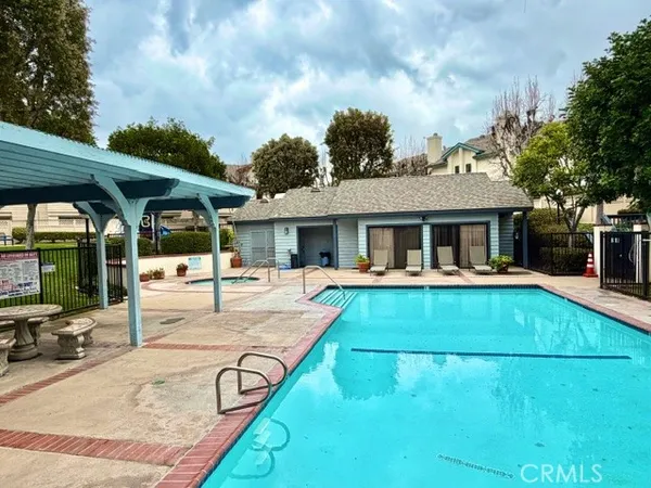 a view of house with swimming pool and sitting area