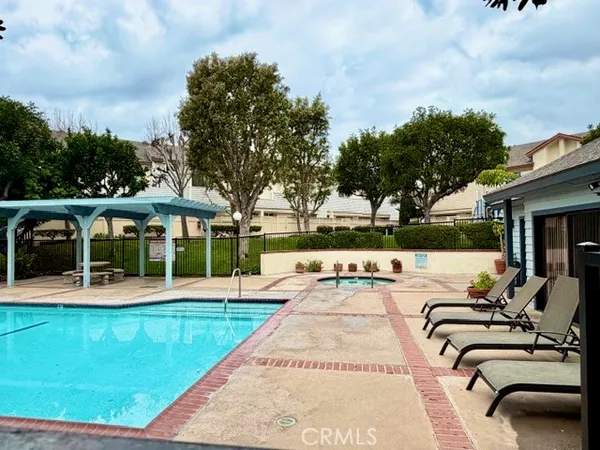 a view of a house with swimming pool and sitting area