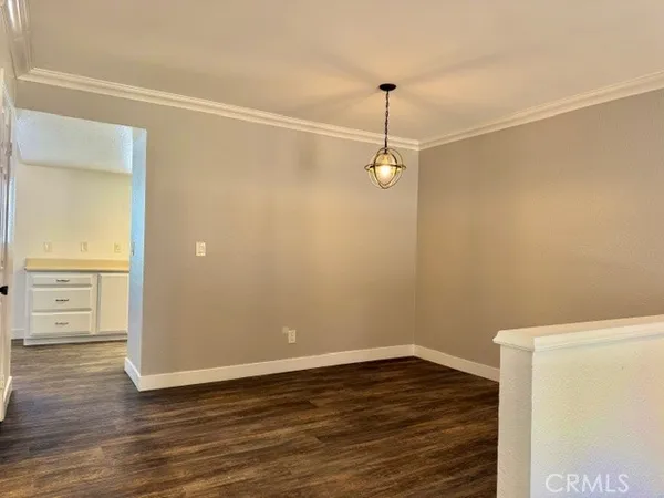 a view of a room with wooden floor
