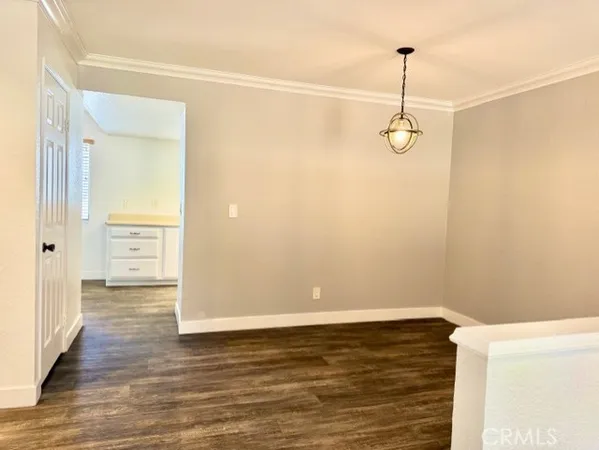 a view of a room with wooden floor