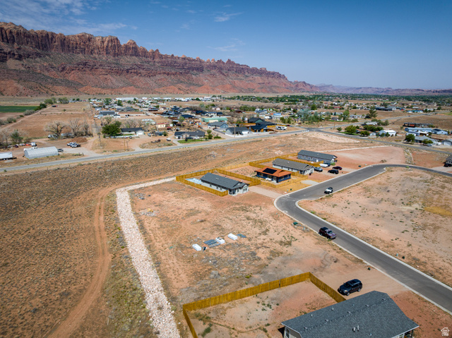 212 Lidia Circle, Unit 17 Moab, UT 84532 - Photo 6 of 24 Aerial perspective showcasing residential properties with a mountainous backdrop