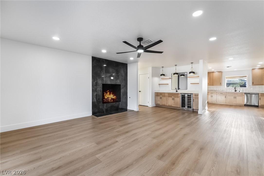 429 Crestway Road Henderson, NV 89015 - Photo 14 of 56 A striking fireplace and wet bar anchor this inviting open-concept living space.