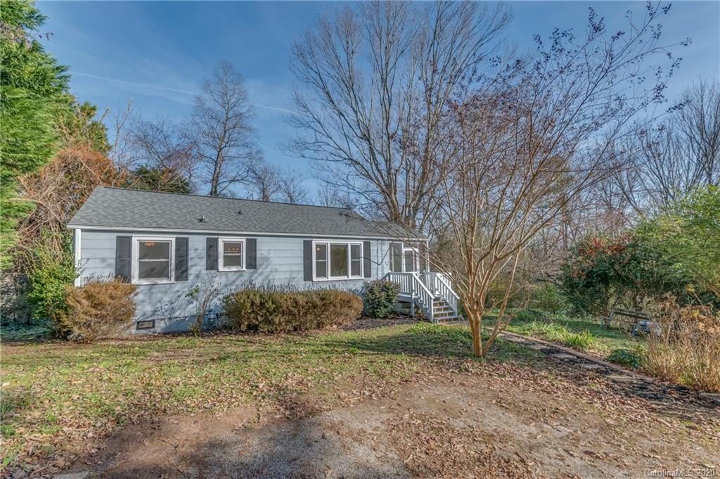 243 Woodland Road Tryon, NC 28782 - Photo 2 of 24 front view of a house with a yard