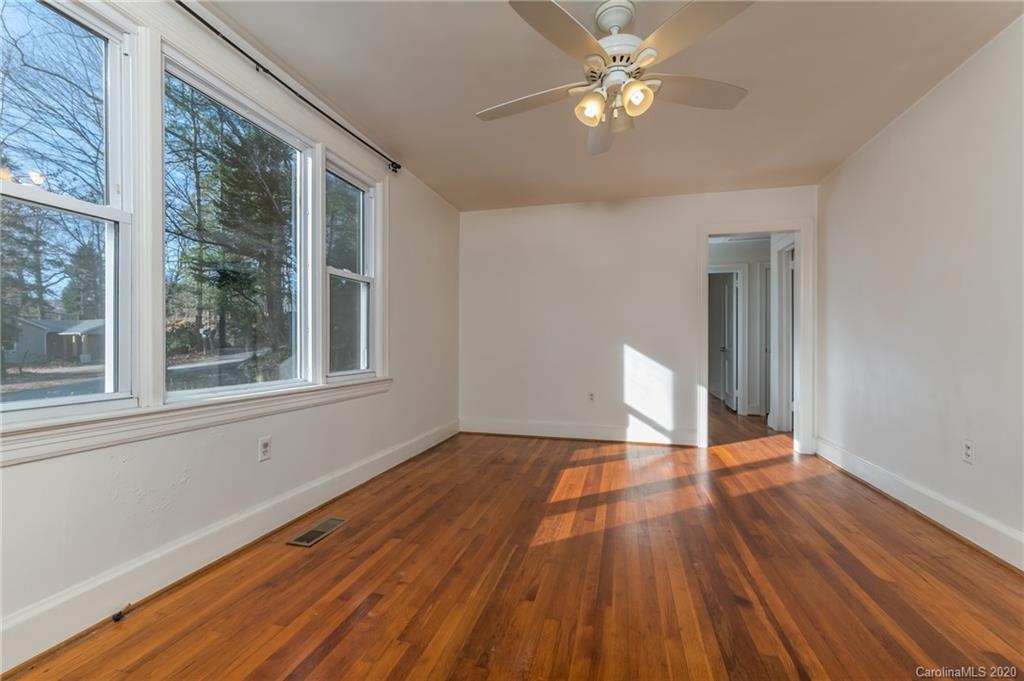 243 Woodland Road Tryon, NC 28782 - Photo 12 of 24 a view of an empty room with wooden floor and a window