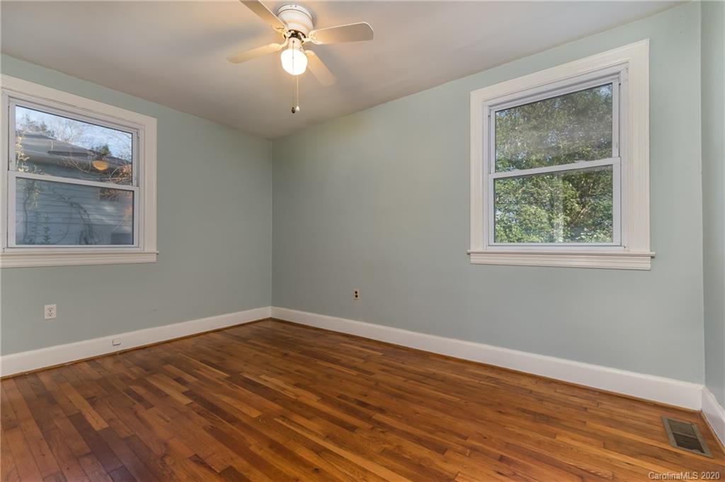 243 Woodland Road Tryon, NC 28782 - Photo 17 of 24 a view of an empty room with wooden floor and a window