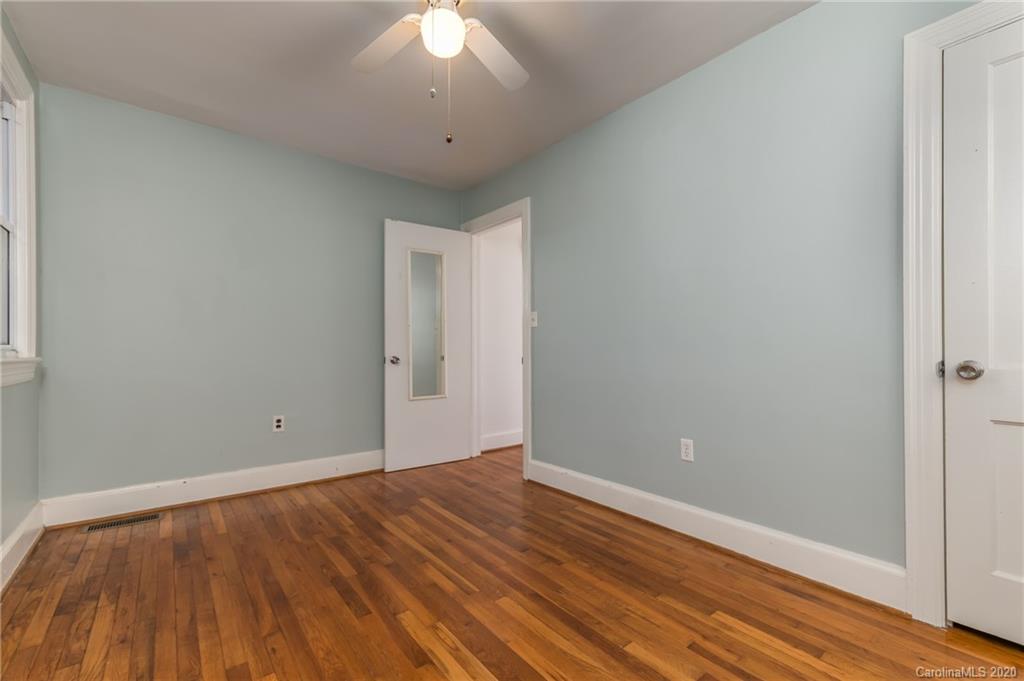 243 Woodland Road Tryon, NC 28782 - Photo 18 of 24 a view of an empty room with wooden floor and a window