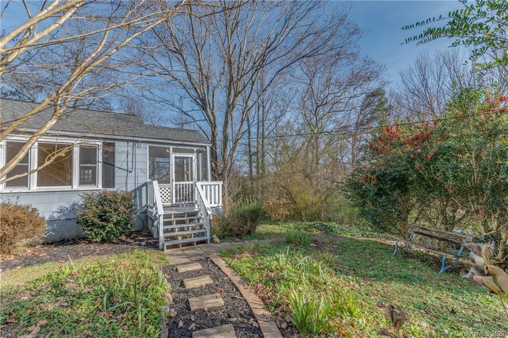 243 Woodland Road Tryon, NC 28782 - Photo 3 of 24 a front view of a house with garden
