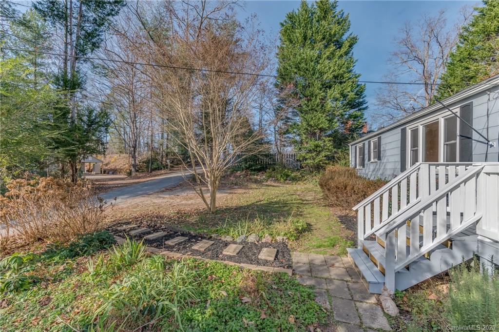 243 Woodland Road Tryon, NC 28782 - Photo 5 of 24 a view of a yard with white house