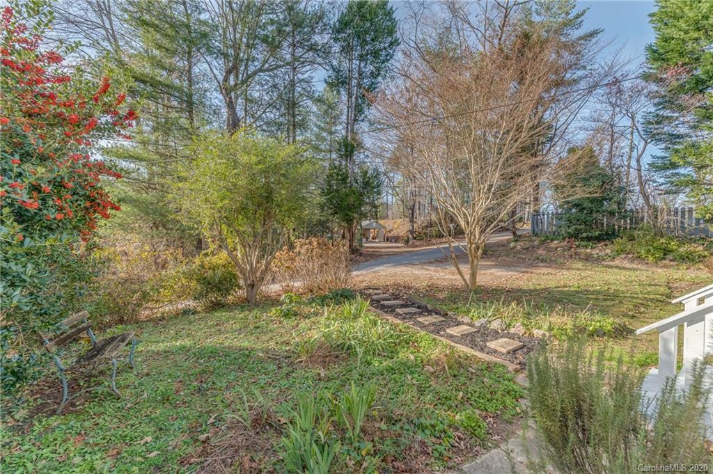 243 Woodland Road Tryon, NC 28782 - Photo 6 of 24 a view of a yard with a tree