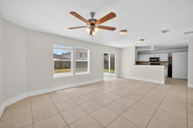 a view of a livingroom with a ceiling fan and window