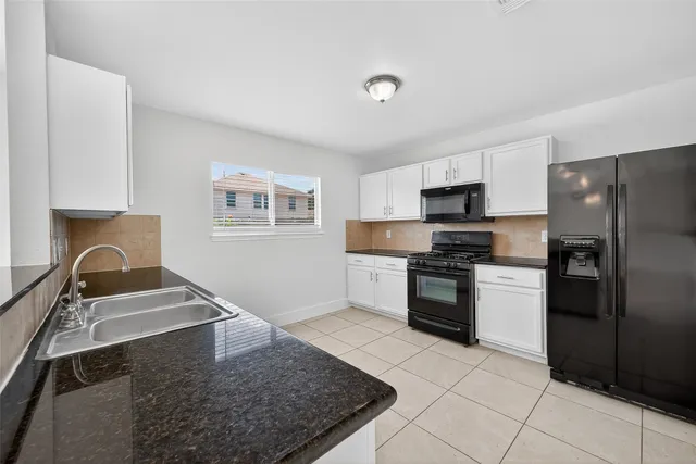 a kitchen with a refrigerator stove and sink