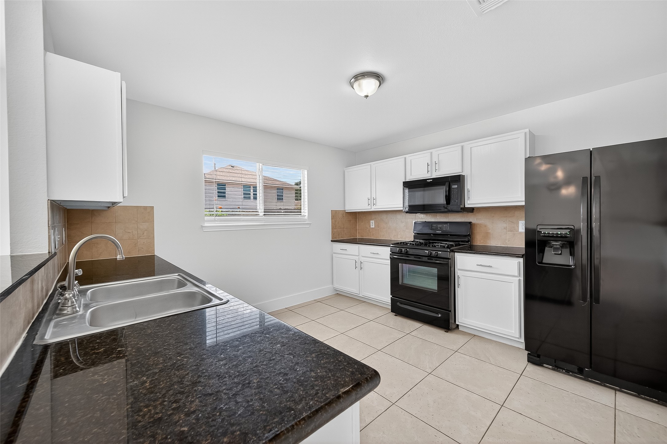 20907 Baronsledge Lane Katy, TX 77449 - Photo 20 of 50 a kitchen with a refrigerator stove and sink