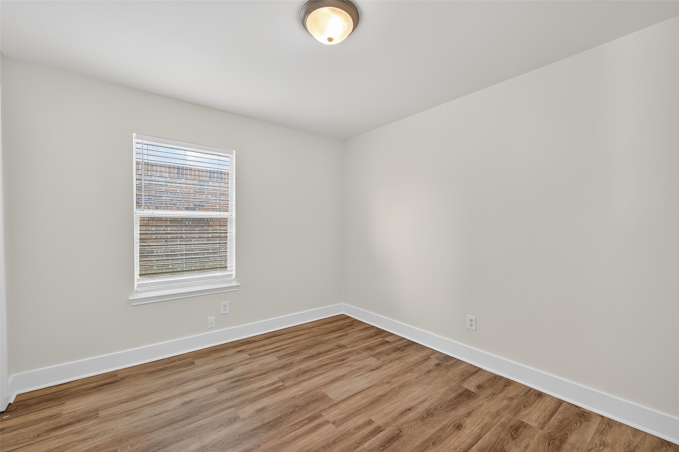 20907 Baronsledge Lane Katy, TX 77449 - Photo 27 of 50 a view of an empty room with wooden floor and a window