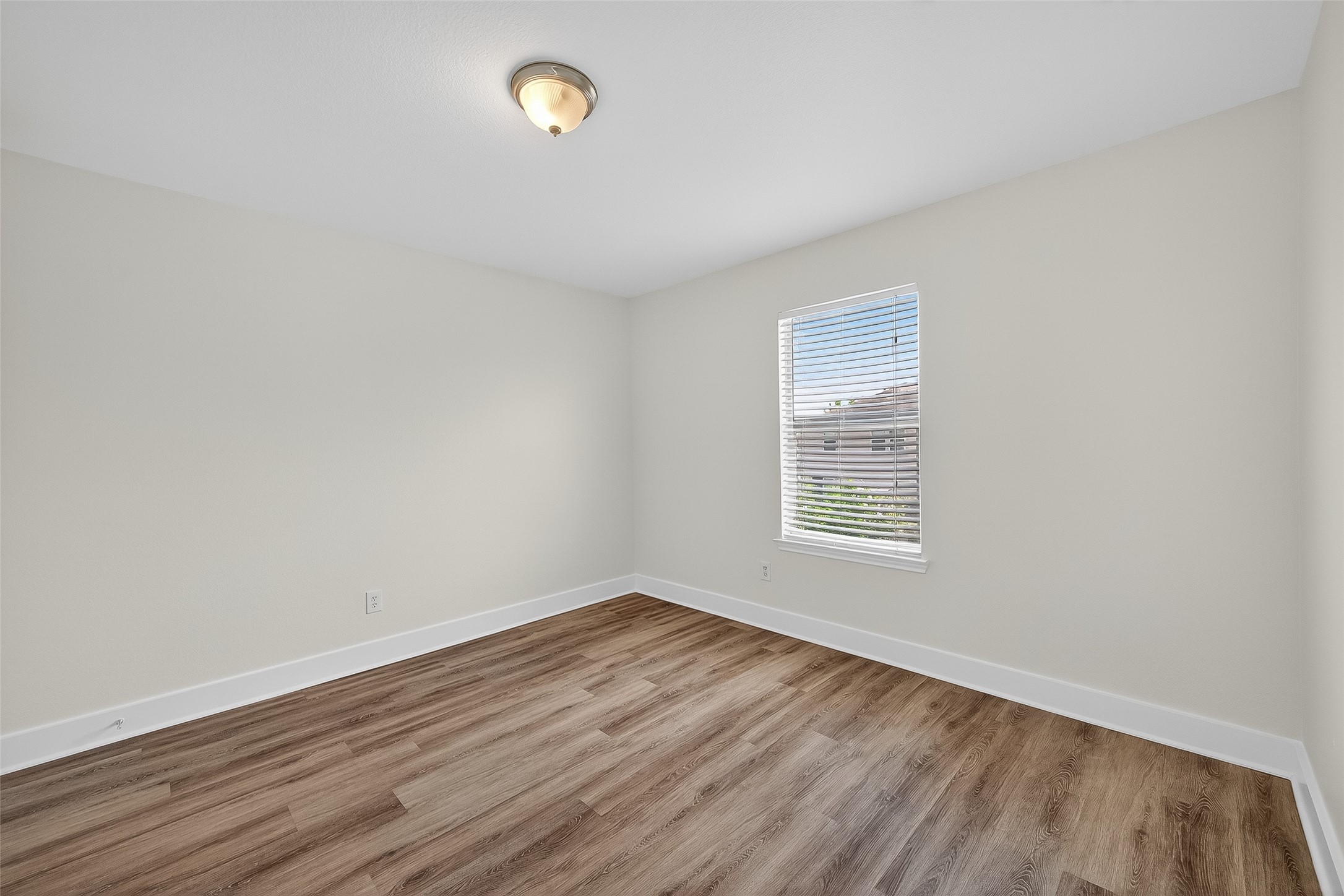 20907 Baronsledge Lane Katy, TX 77449 - Photo 31 of 50 a view of an empty room with wooden floor and a window