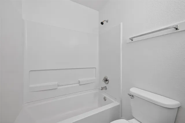 a bathroom with a toilet and a bathtub