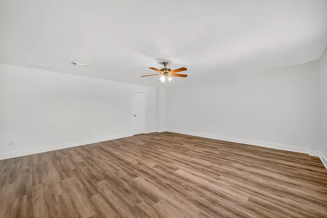 a view of a room with wooden floor