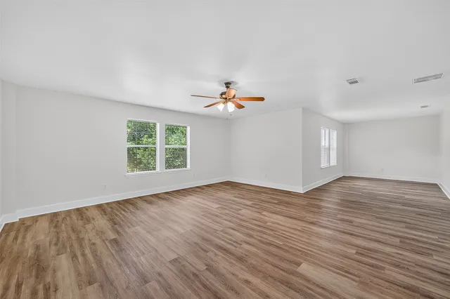 wooden floor in an empty room with a window