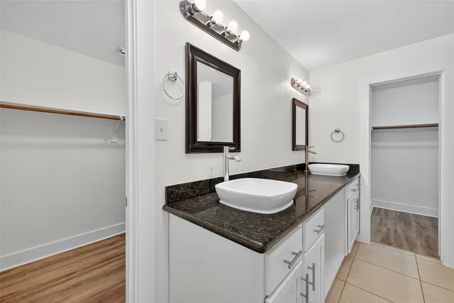 a bathroom with a granite countertop sink a mirror and a