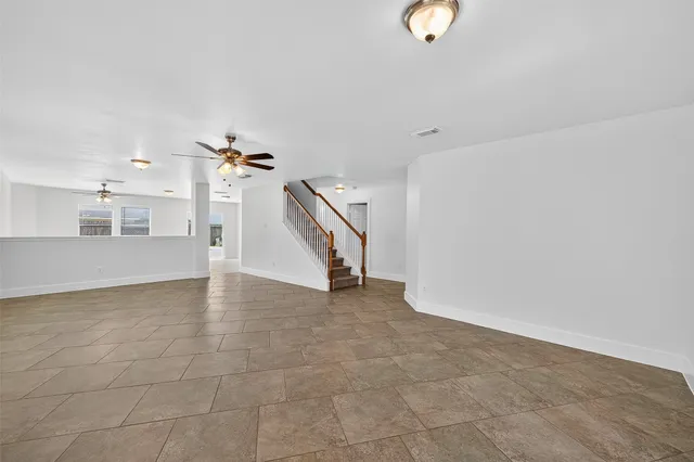 a view of a livingroom with wooden floor and stairs