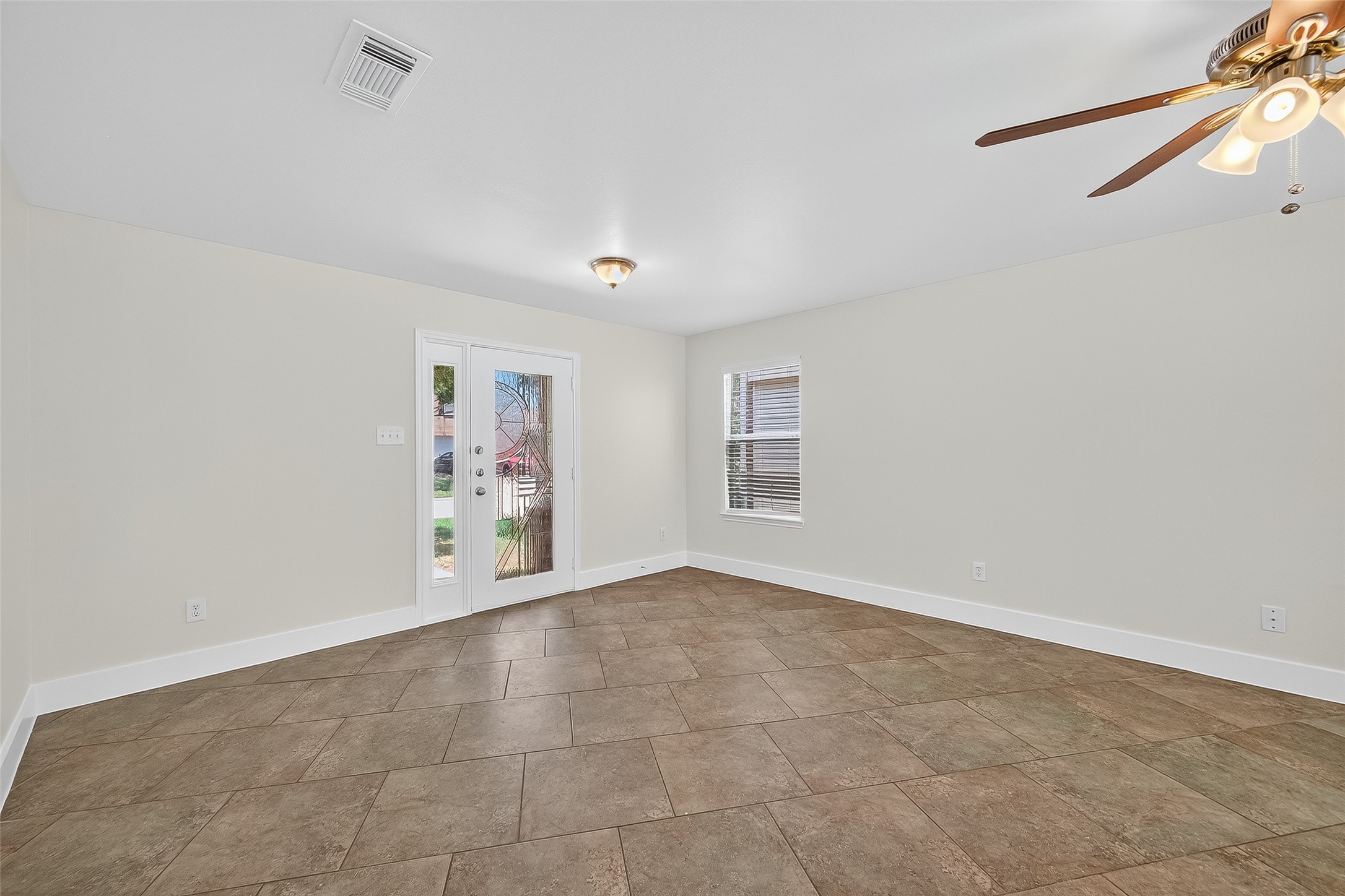 20907 Baronsledge Lane Katy, TX 77449 - Photo 9 of 50 an empty room with windows and chandelier fan