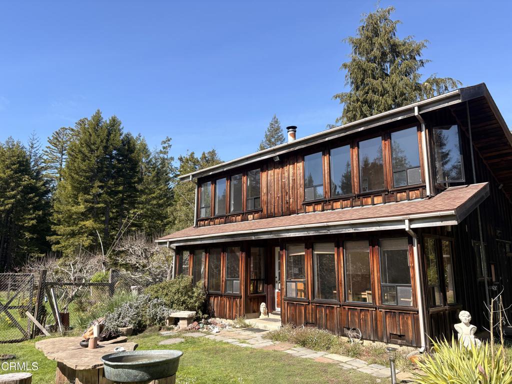 a view of a house with pool and chairs