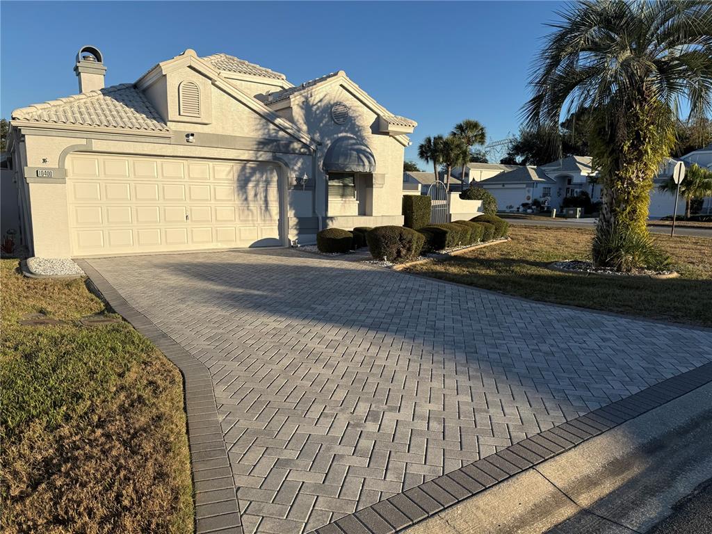 10400 Casa Grande Circle Spring Hill, FL 34608 - Photo 2 of 55 a front view of a house with garden