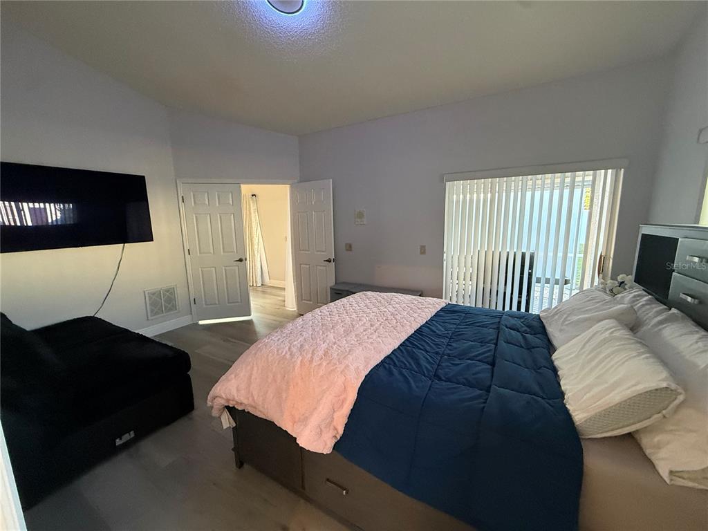 10400 Casa Grande Circle Spring Hill, FL 34608 - Photo 22 of 55 a bedroom with a bed and a television