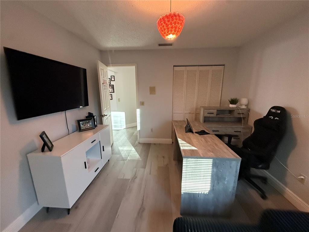 10400 Casa Grande Circle Spring Hill, FL 34608 - Photo 31 of 55 a living room with furniture and a flat screen tv