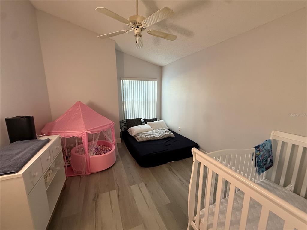 10400 Casa Grande Circle Spring Hill, FL 34608 - Photo 34 of 55 a bedroom with a bed and a window