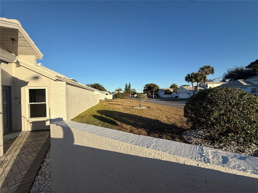 10400 Casa Grande Circle Spring Hill, FL 34608 - Photo 39 of 55 a view of a balcony with two chairs and a potted plant
