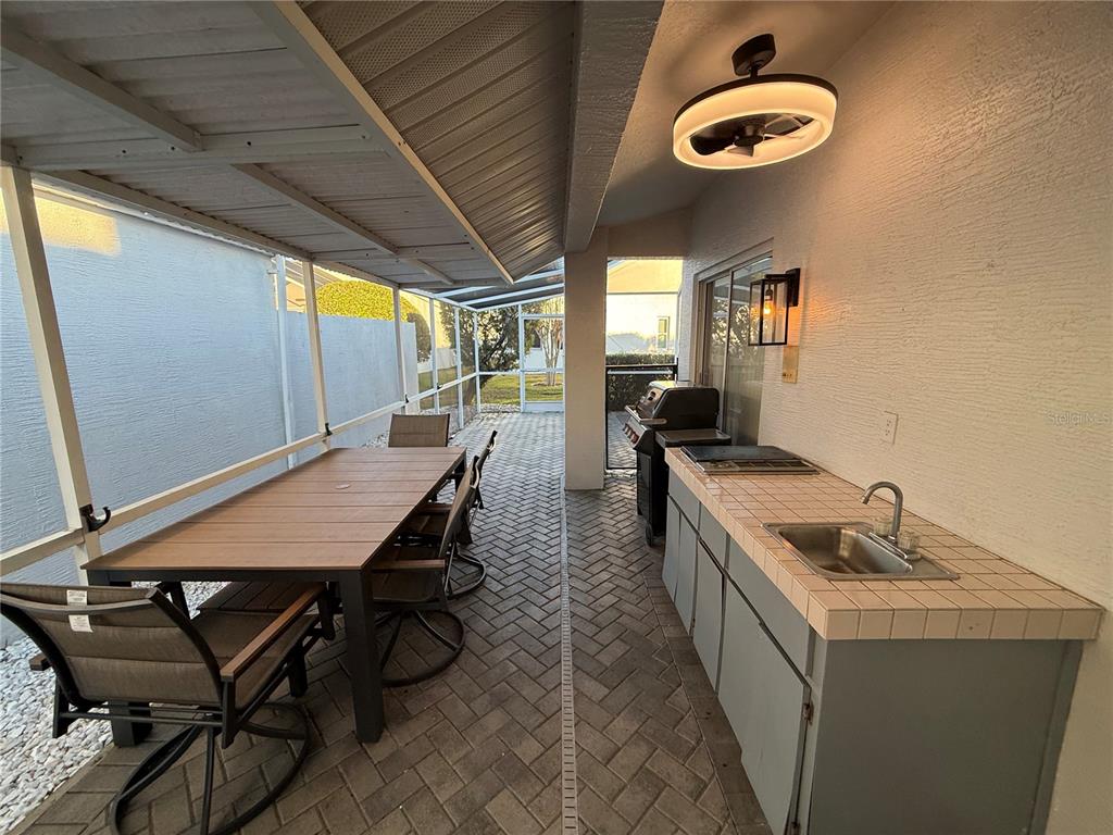 10400 Casa Grande Circle Spring Hill, FL 34608 - Photo 52 of 55 a dining room with furniture and a floor to ceiling window