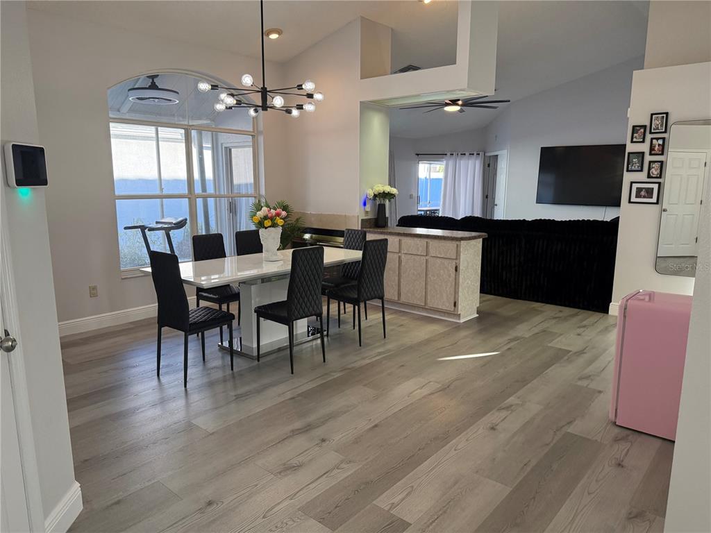 10400 Casa Grande Circle Spring Hill, FL 34608 - Photo 7 of 55 a view of a dining room with furniture and chandelier