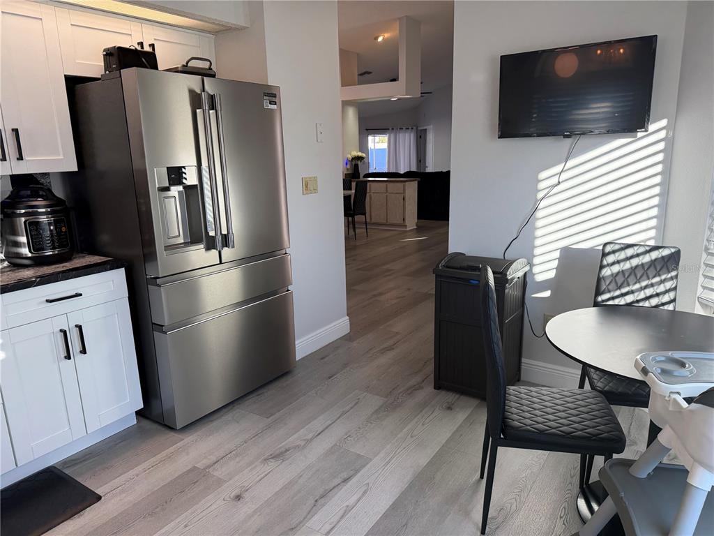 10400 Casa Grande Circle Spring Hill, FL 34608 - Photo 10 of 55 a kitchen with stainless steel appliances wooden floor and a refrigerator
