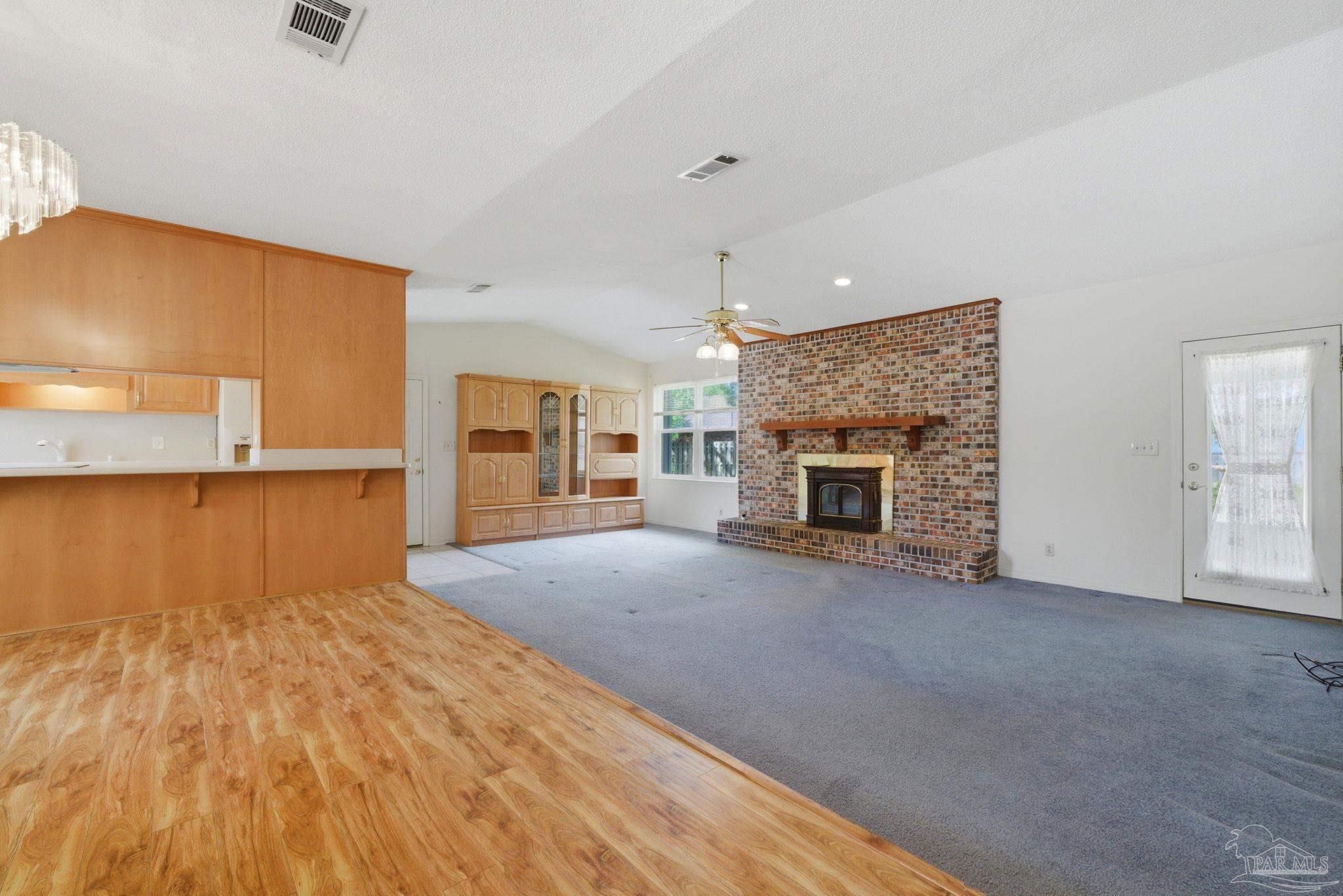 4320 Grant Street Pace, FL 32571 - Photo 11 of 27 a view of a livingroom with a fireplace